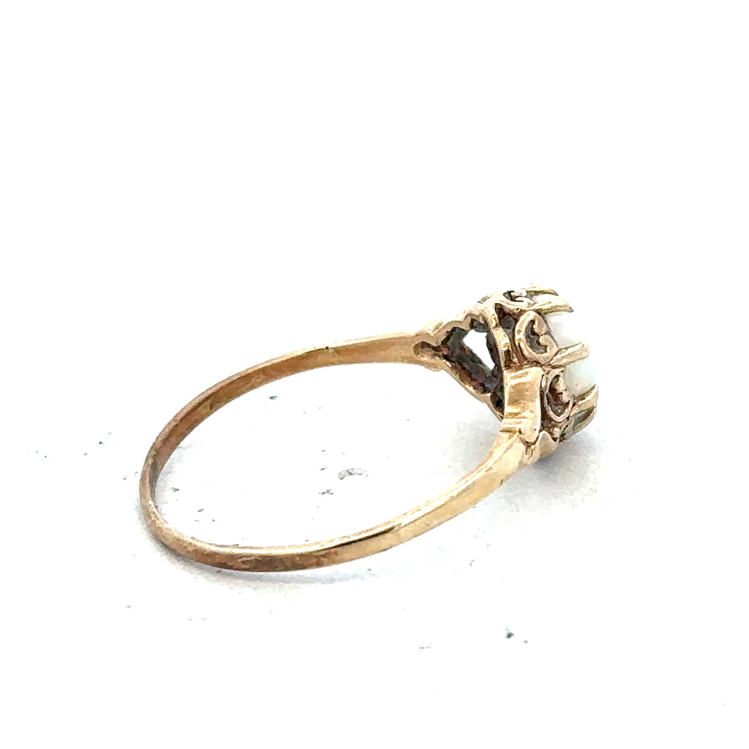 9ct yellow gold opal ring in size P with a vibrant opal gemstone, featuring a simple gold band design.