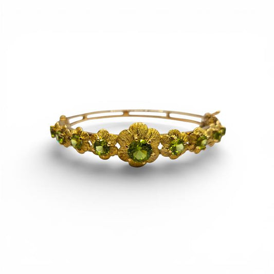 9ct yellow gold peridot bangle bracelet with vibrant green gemstones and elegant design, unbranded jewelry accessory.