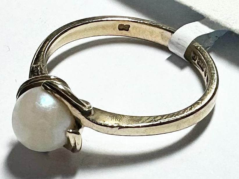 Yellow gold ring in size L 1/2, unbranded 9ct gold jewelry, close-up view showing smooth band and polished finish.