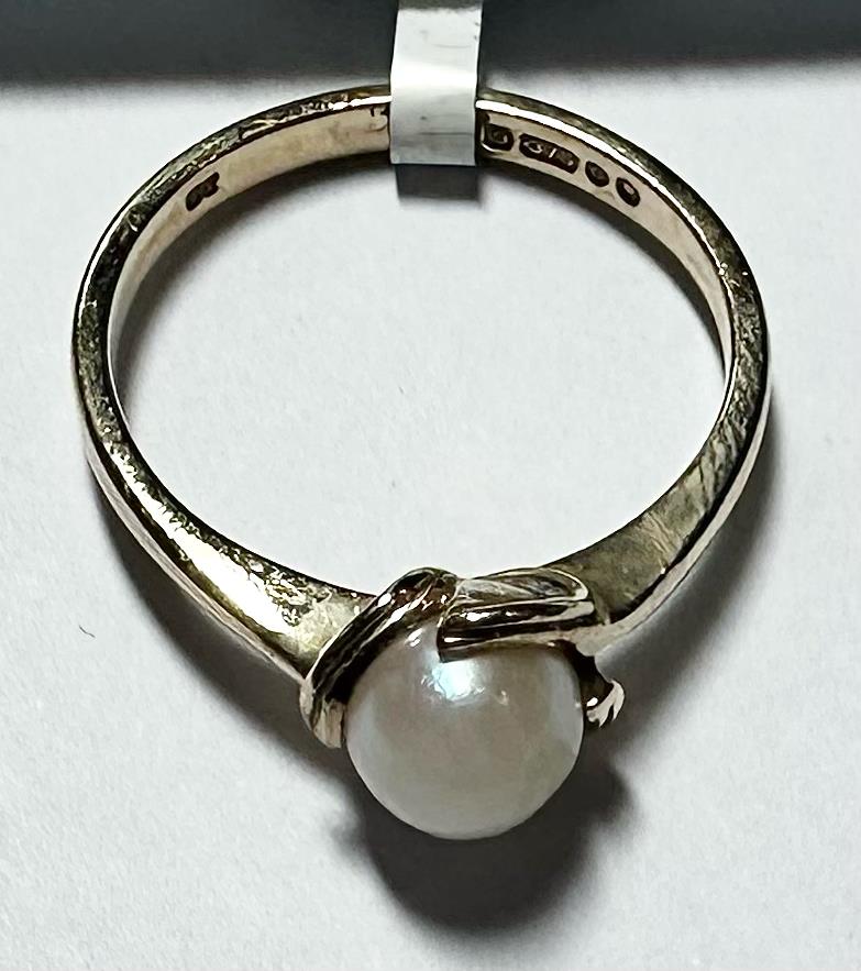 9ct yellow gold ring in size L1/2 with a smooth band, unbranded, shown in a close-up view.