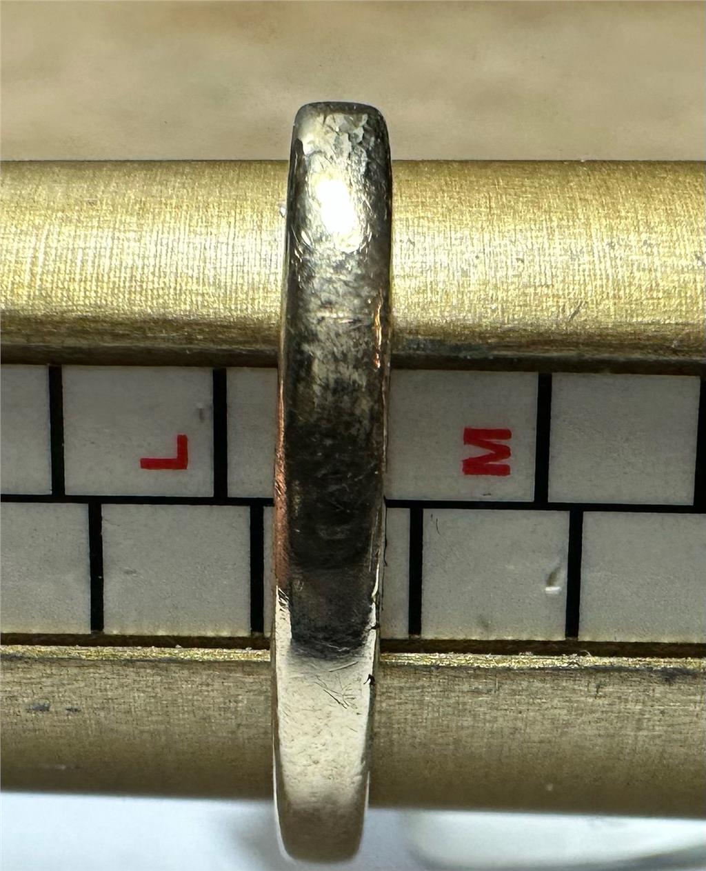 Yellow gold ring in size L 1/2, unbranded 9ct gold ring with a smooth band design, detailed close-up image.