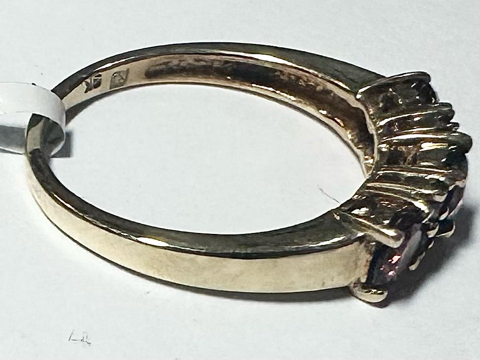 9ct yellow gold ring in size M with a simple, smooth band, unbranded, shown in a close-up view.