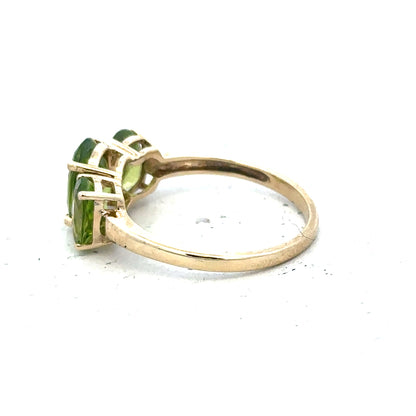 9ct yellow gold ring size P, unbranded, with a smooth polished band, shown from a side angle highlighting its elegant design.