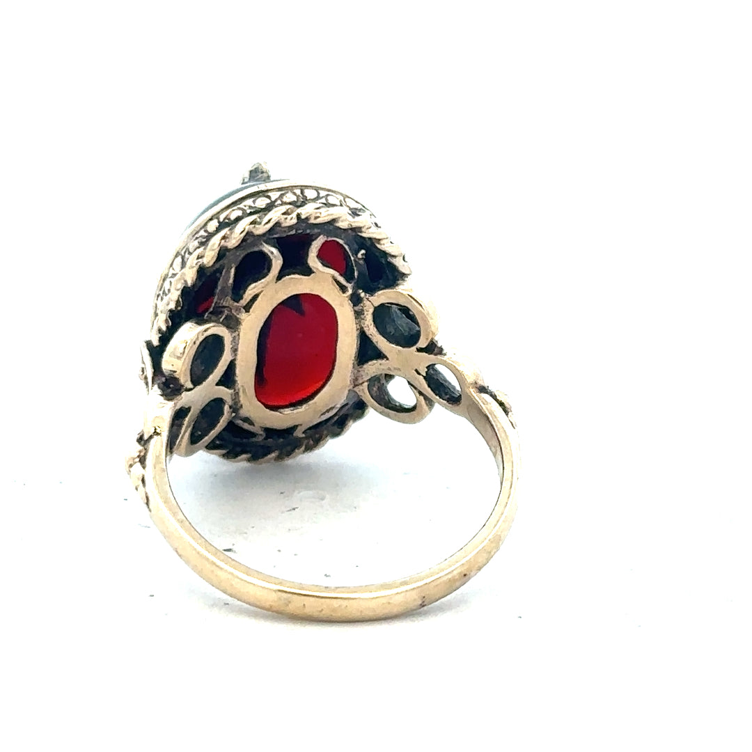 9ct yellow gold ring in size P with a smooth band, unbranded jewelry piece displayed against a neutral background.