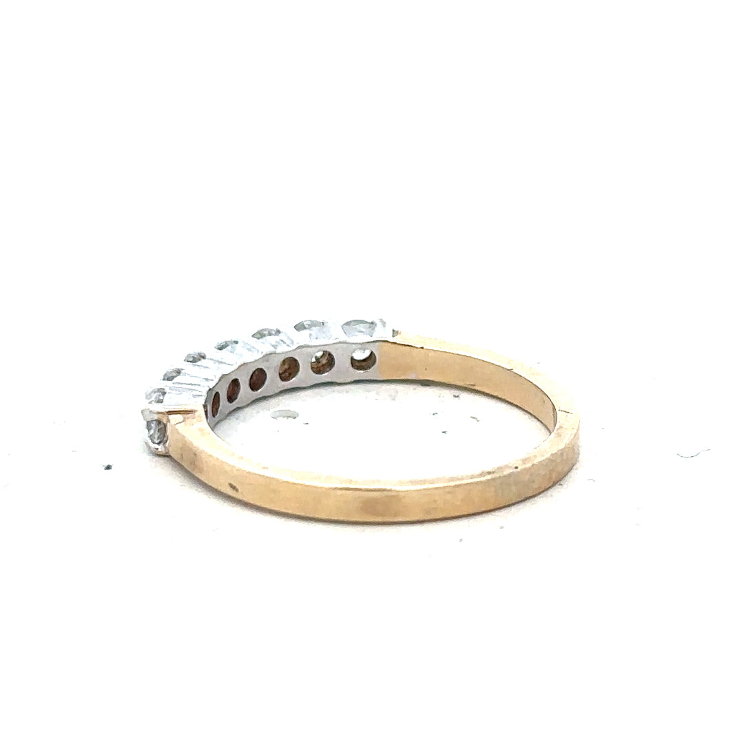 9ct yellow gold ring in size P with a simple band design, unbranded, shown from a side angle.