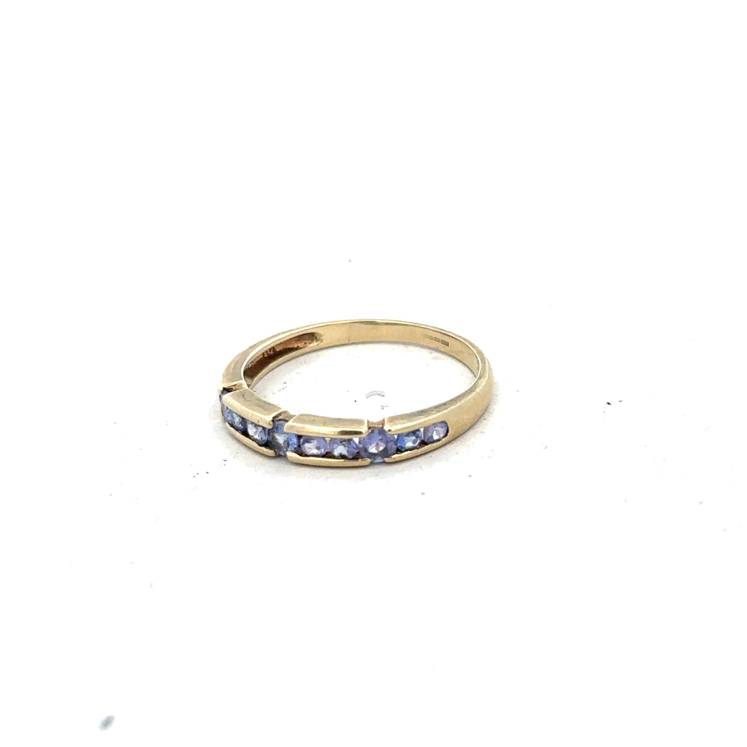 9ct yellow gold ring in size P with a smooth band, unbranded jewelry accessory, shown from a side angle.