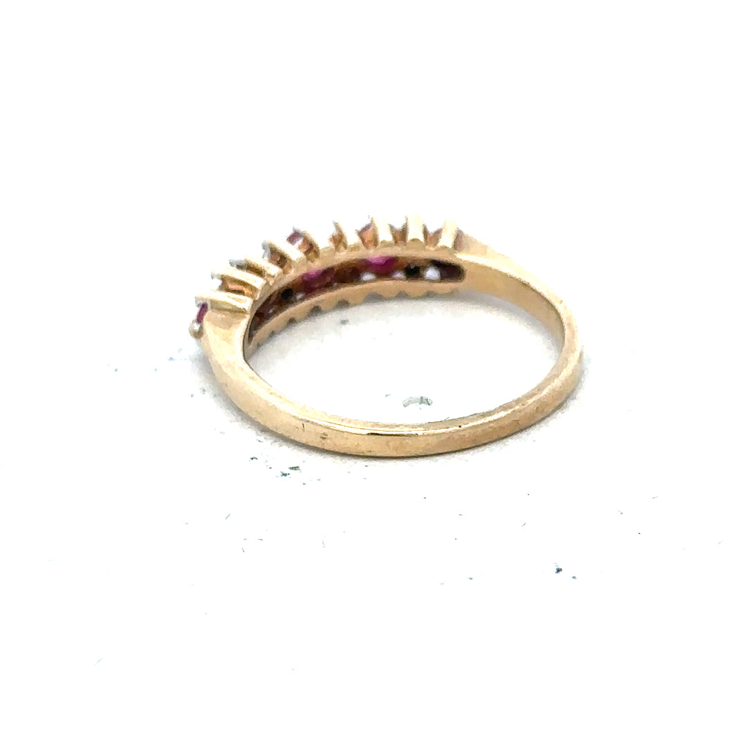 9ct yellow gold ruby and diamond ring, size J1/2, featuring a central ruby surrounded by small diamonds.