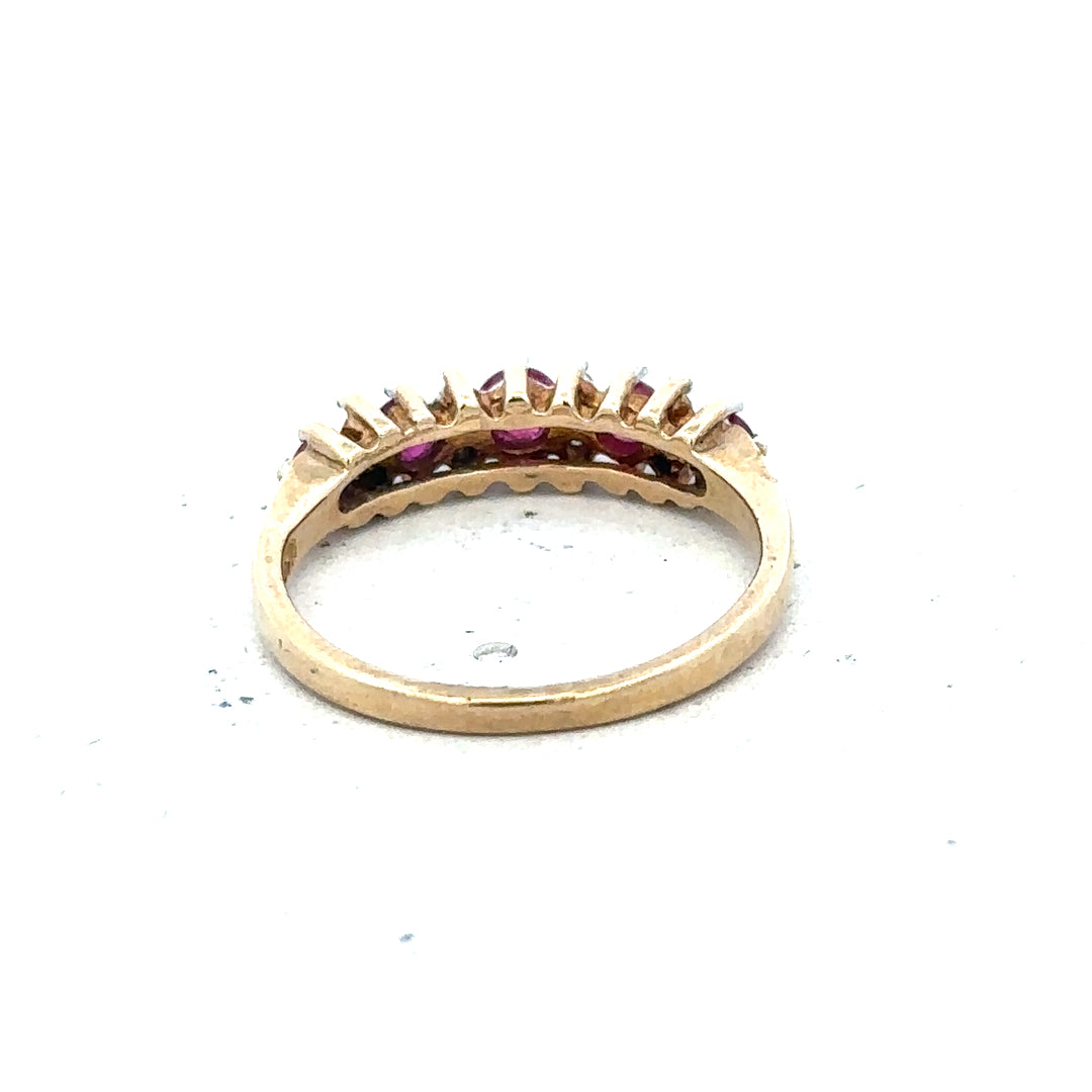 9ct yellow gold ruby and diamond ring in size J1/2, featuring a detailed band with sparkling gemstones.