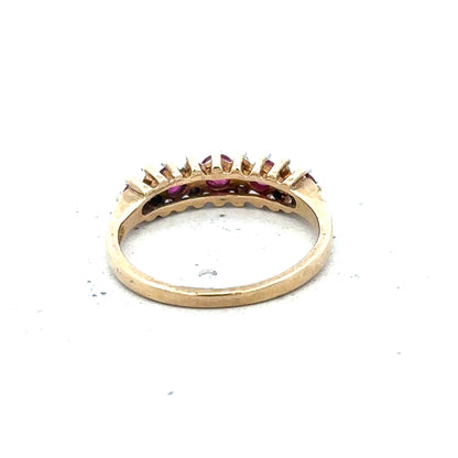 9ct yellow gold ruby and diamond ring in size J1/2, featuring a detailed band with sparkling gemstones.