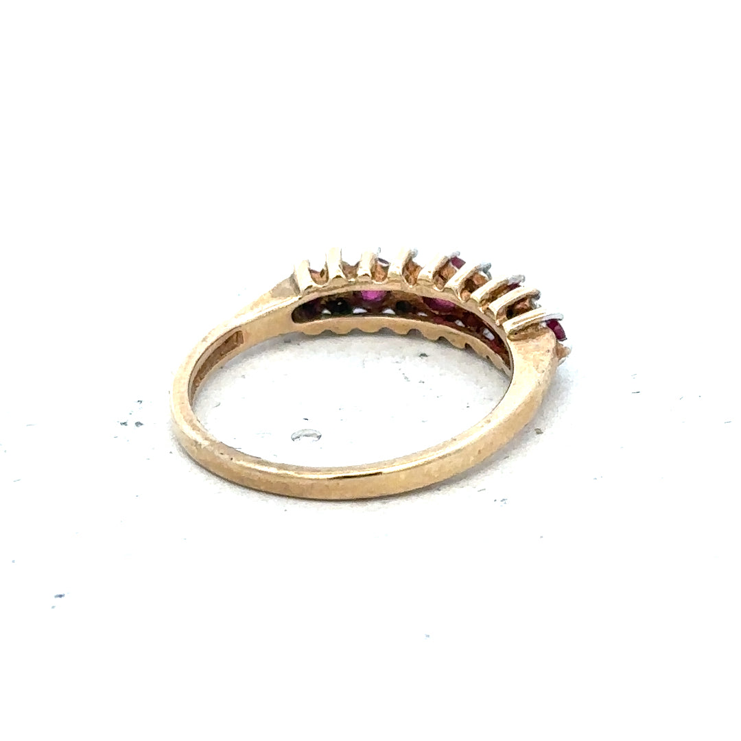 9ct yellow gold ruby and diamond ring, size J½, unbranded, showcasing a gold band with a central ruby and sparkling diamonds.
