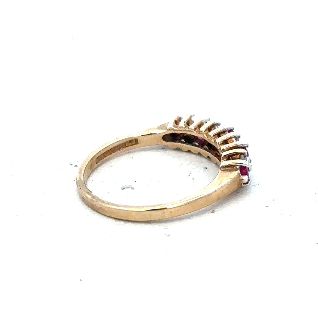 9ct yellow gold ruby and diamond ring, size J½, featuring a central ruby gemstone and sparkling diamonds.