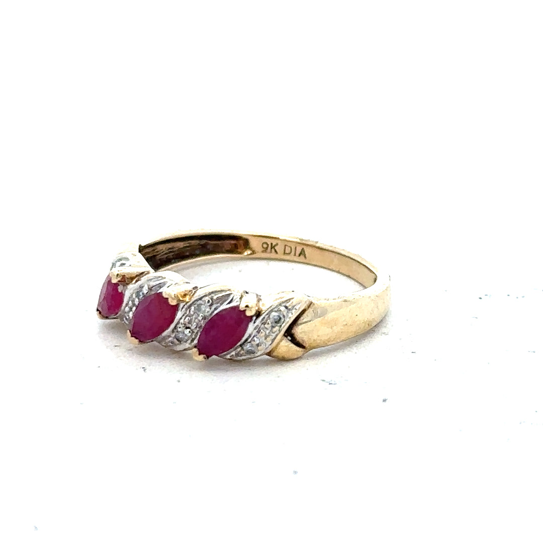 9ct yellow gold ruby and diamond ring, size L, featuring a central ruby surrounded by small diamonds on a polished band.