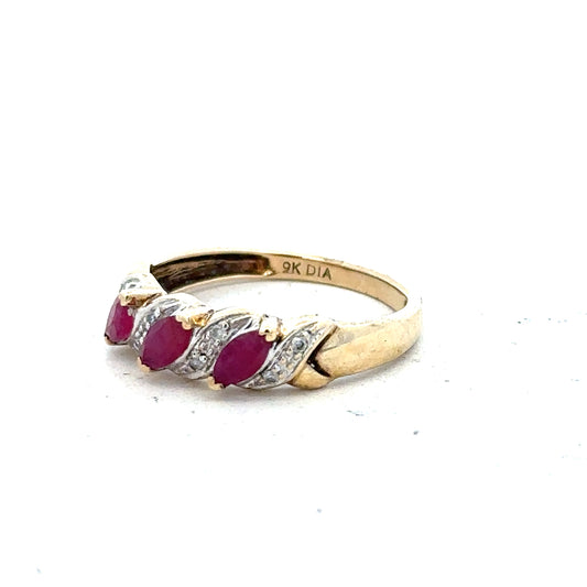 9ct yellow gold ruby and diamond ring, size L, featuring a central ruby surrounded by small diamonds on a polished band.