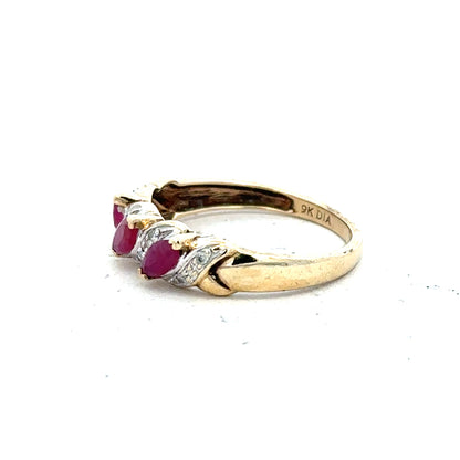 9ct yellow gold ruby and diamond ring in size L, featuring a central ruby surrounded by sparkling diamonds.