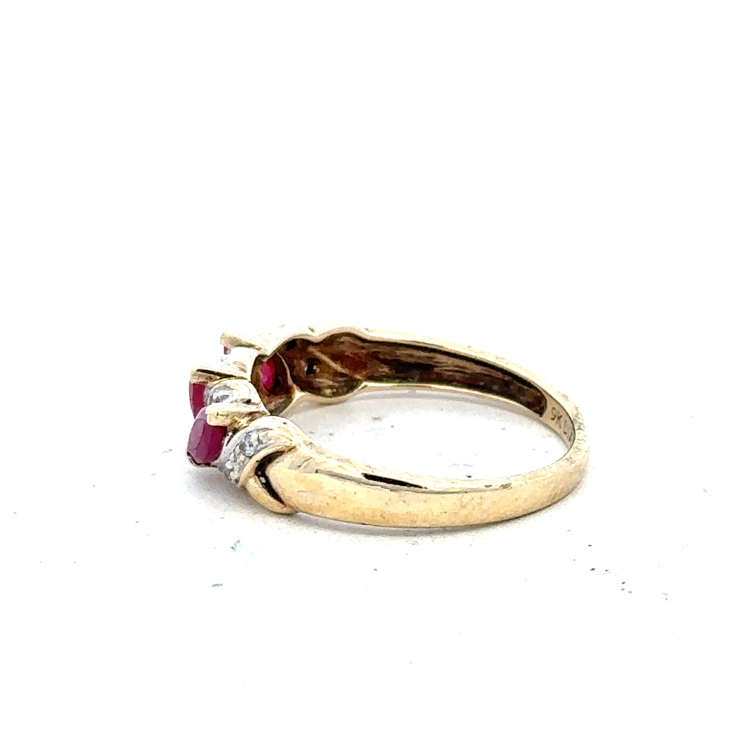 9ct yellow gold ruby and diamond ring in size L, featuring a vibrant ruby centerpiece with sparkling diamonds.
