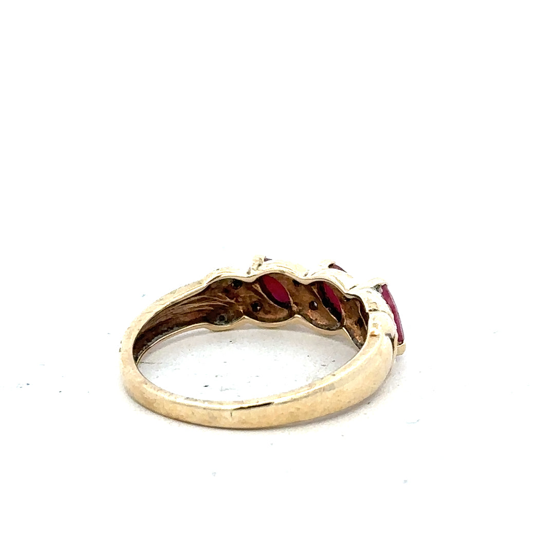9ct yellow gold ring with ruby and diamond accents, size L, showcasing a stylish unbranded jewelry design.