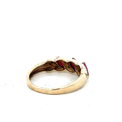 9ct yellow gold ring with ruby and diamond accents, size L, showcasing a stylish unbranded jewelry design.