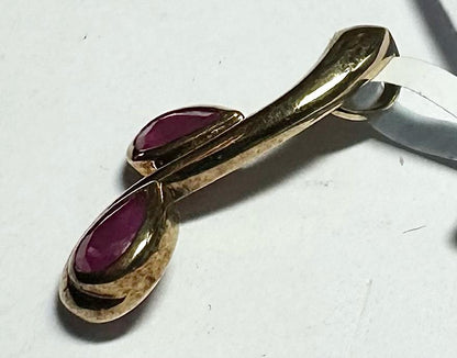 9ct yellow gold ruby pendant with a 1.2g weight, featuring a polished design and vibrant red ruby gemstone.