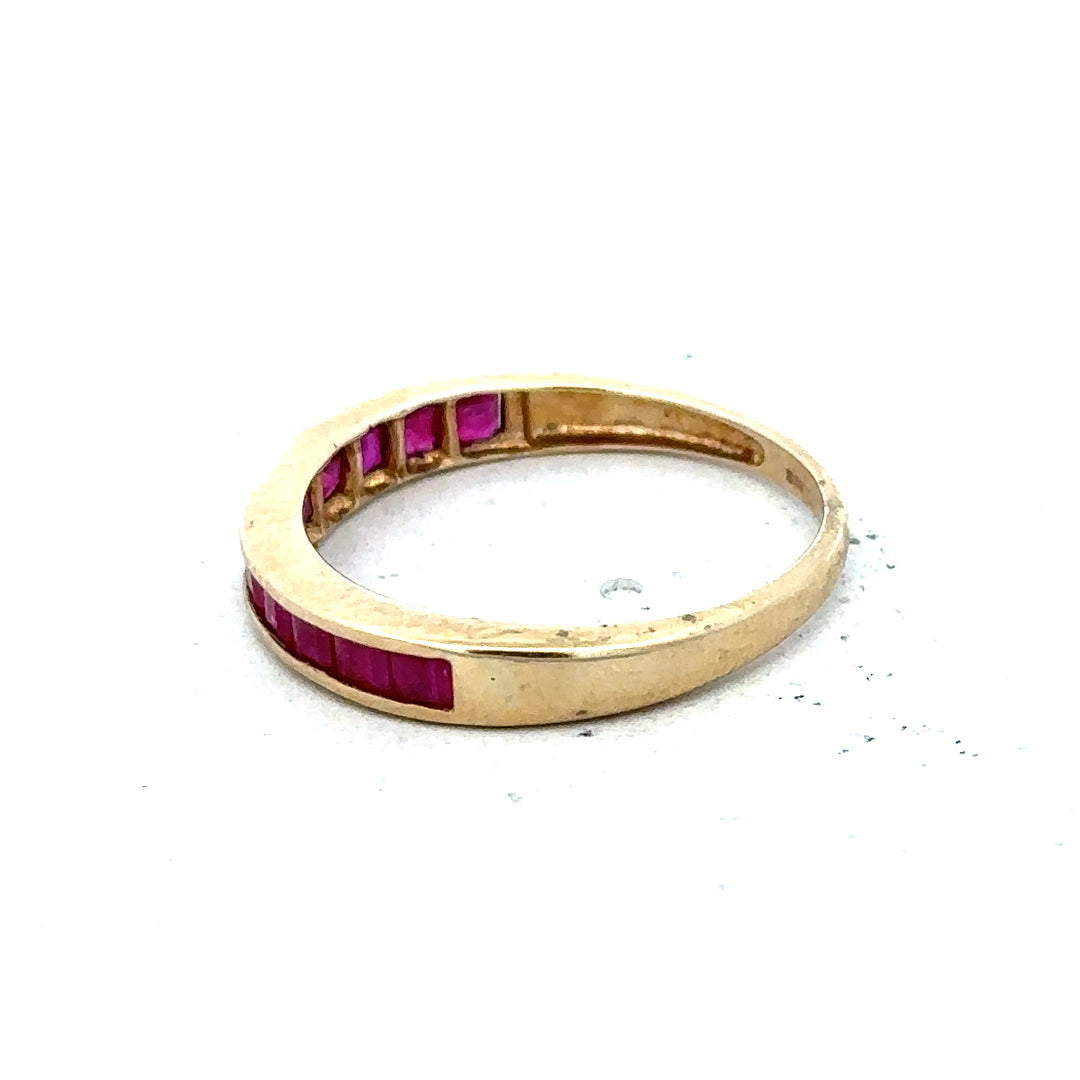 9ct yellow gold ruby ring in size P1/2, featuring a central ruby gemstone set in a simple gold band.