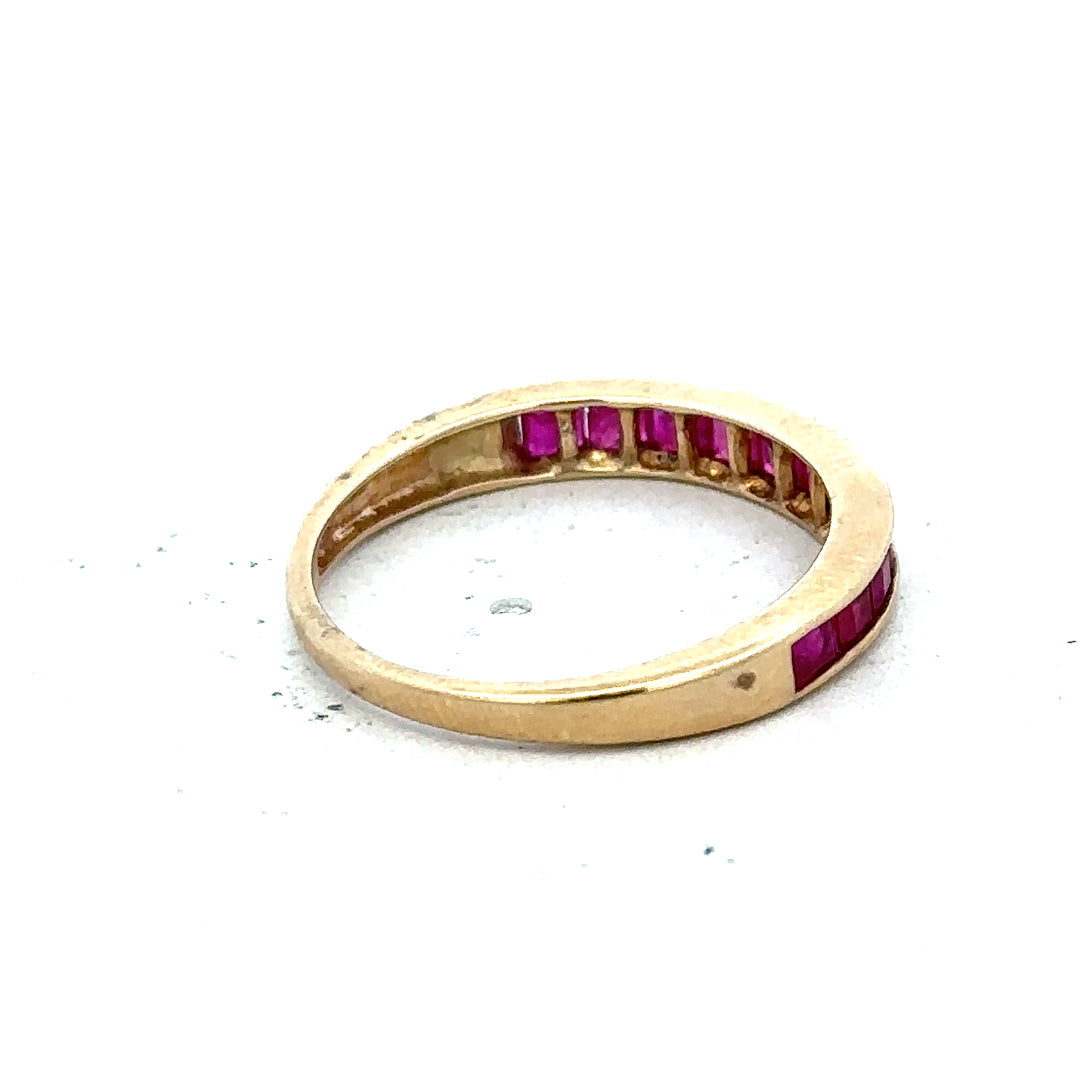 9ct yellow gold ruby ring size P1/2, featuring a vibrant central ruby gemstone set in a simple yellow gold band.