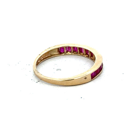 9ct yellow gold ruby ring size P1/2, featuring a vibrant central ruby gemstone set in a simple yellow gold band.