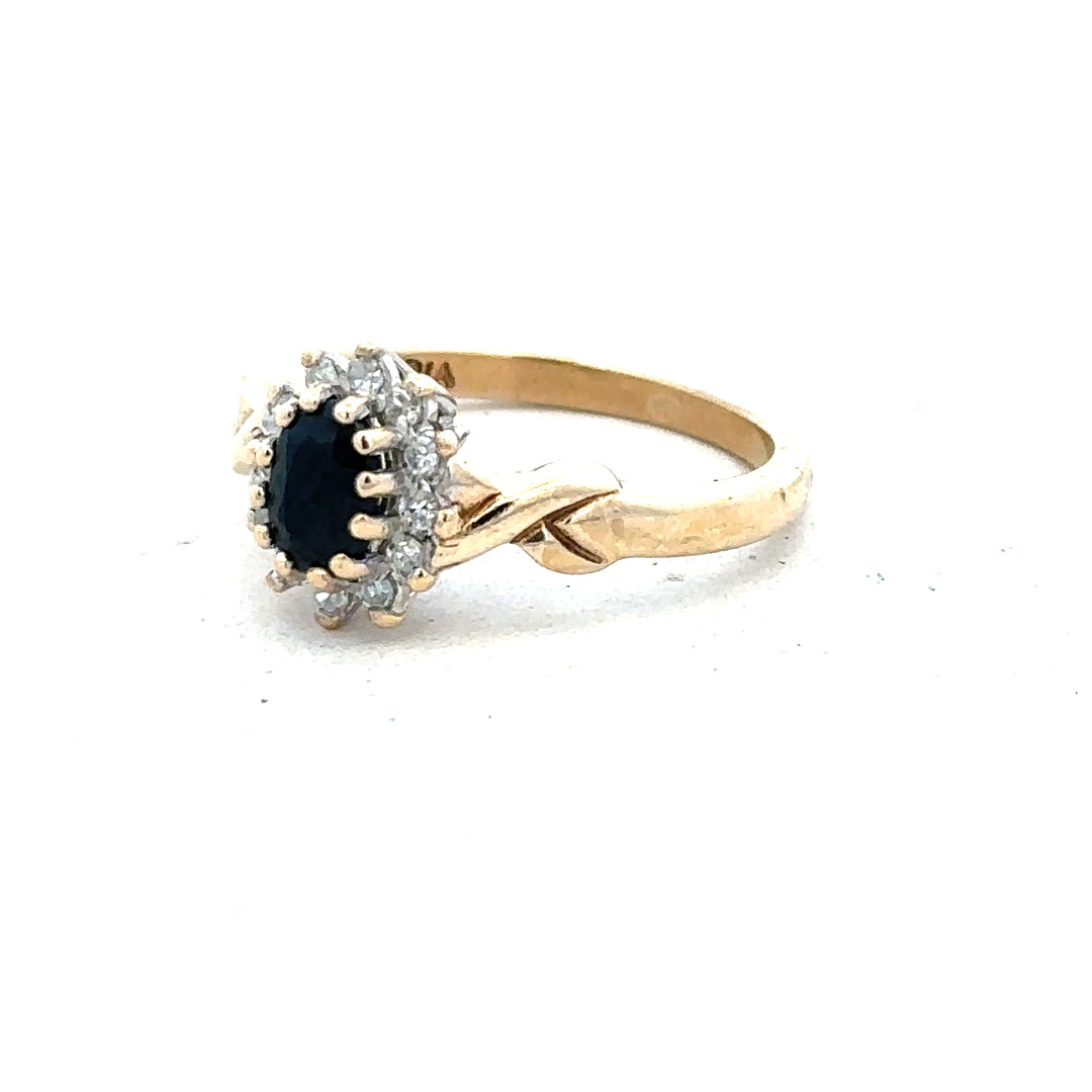 9ct yellow gold sapphire and diamond ring, size K½, featuring a central sapphire gemstone surrounded by small diamonds.