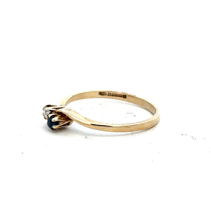 9ct yellow gold sapphire and diamond ring, size M, featuring a central sapphire and sparkling diamonds on an elegant band.