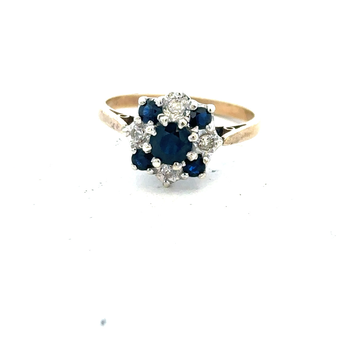 9ct yellow gold sapphire and diamond ring, size P, featuring a central blue sapphire and sparkling diamonds on a polished band.
