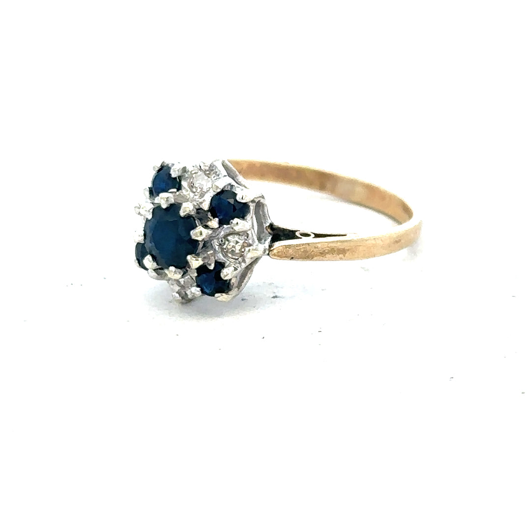 9ct yellow gold sapphire and diamond ring, size P, showcasing a central sapphire with diamond accents on a gold band.