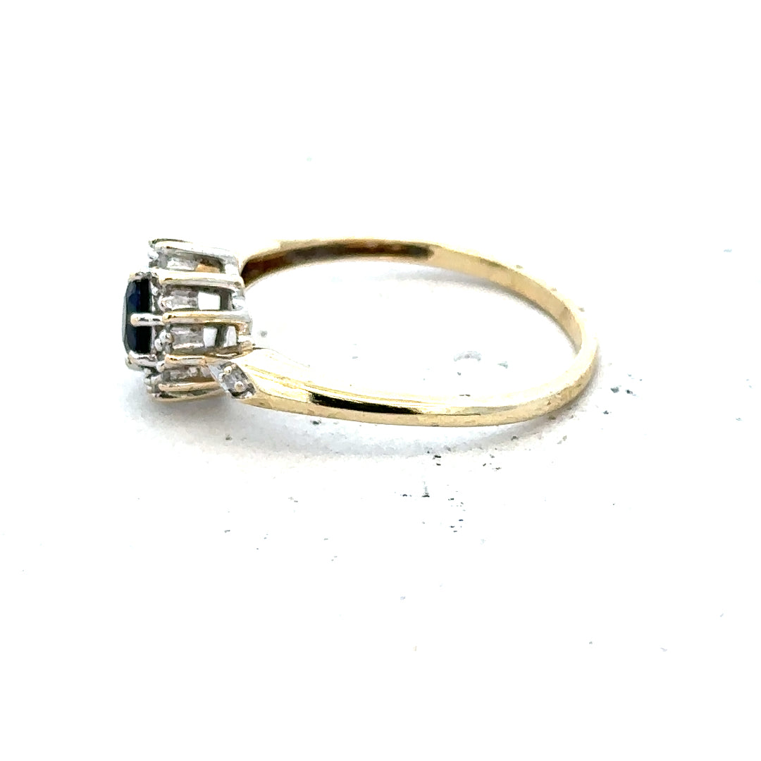 9ct yellow gold sapphire and diamond ring, size P, featuring a central blue sapphire surrounded by sparkling diamonds.