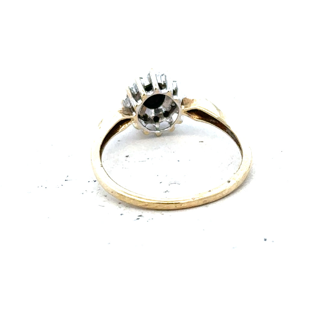 9ct yellow gold sapphire and diamond ring in size P, featuring a central sapphire with diamond accents, unbranded jewelry design.