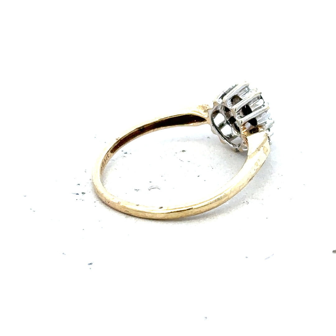 9ct yellow gold sapphire and diamond ring in size P, featuring a central sapphire with surrounding diamonds.