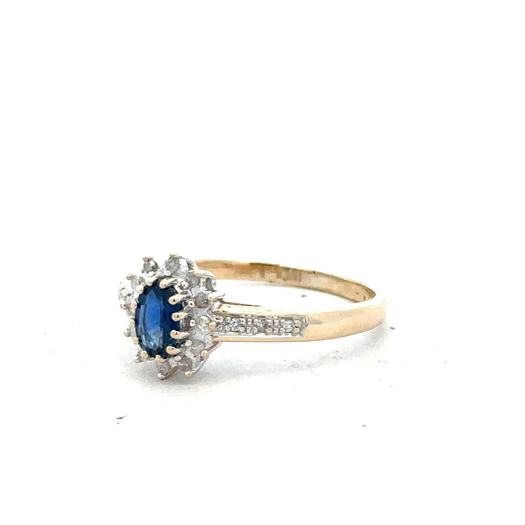 9ct yellow gold sapphire and diamond ring in size P1/2, featuring a detailed gemstone design and elegant band.