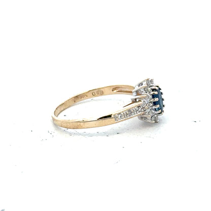 9ct yellow gold sapphire and diamond ring in size P1/2, featuring a detailed design with sparkling gemstones.