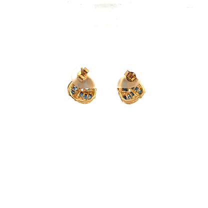 9ct yellow gold sapphire earrings with a delicate design, shown resting on a white background. Unbranded jewelry.