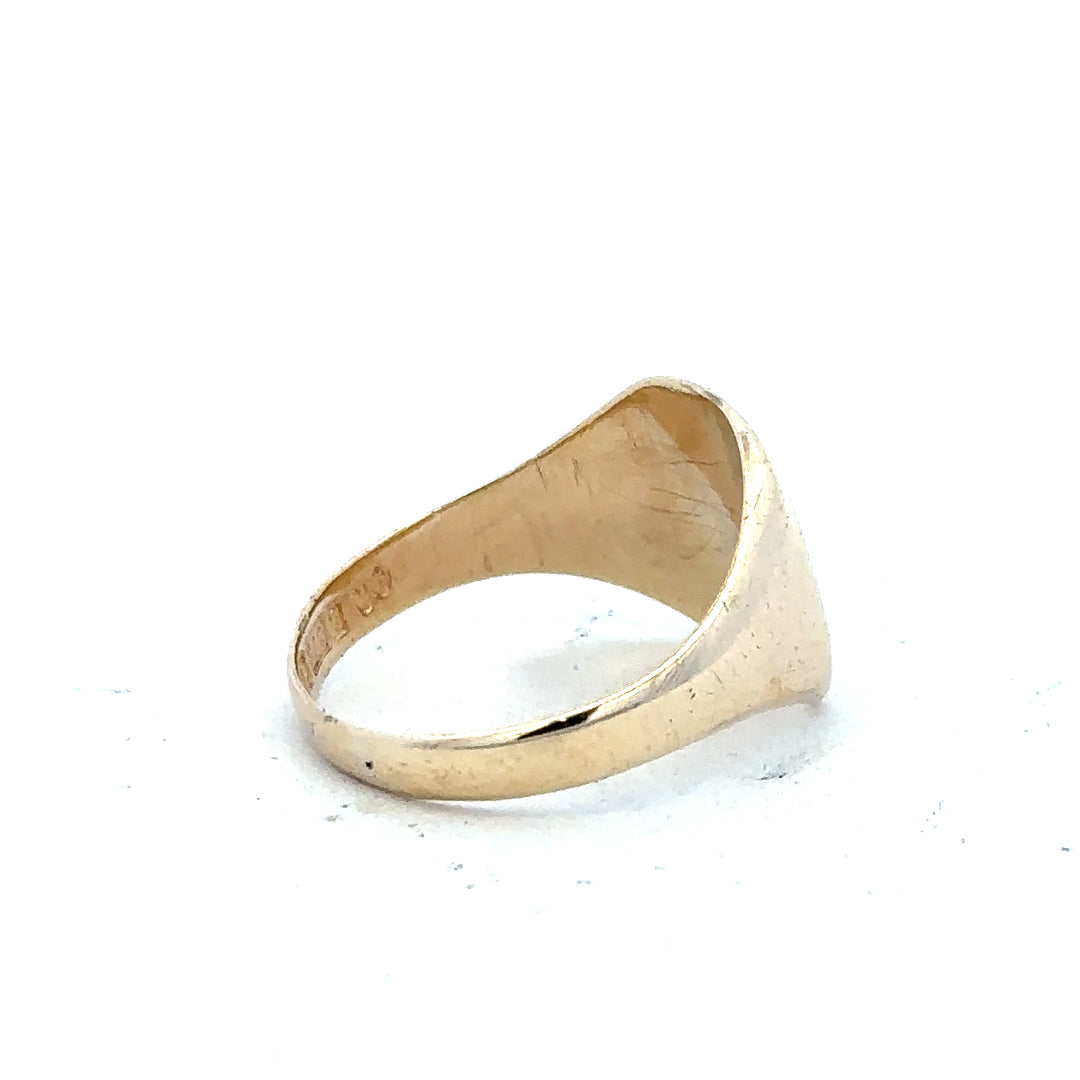 9ct yellow gold signet ring in size S with a smooth polished surface, unbranded jewelry piece, close-up view.