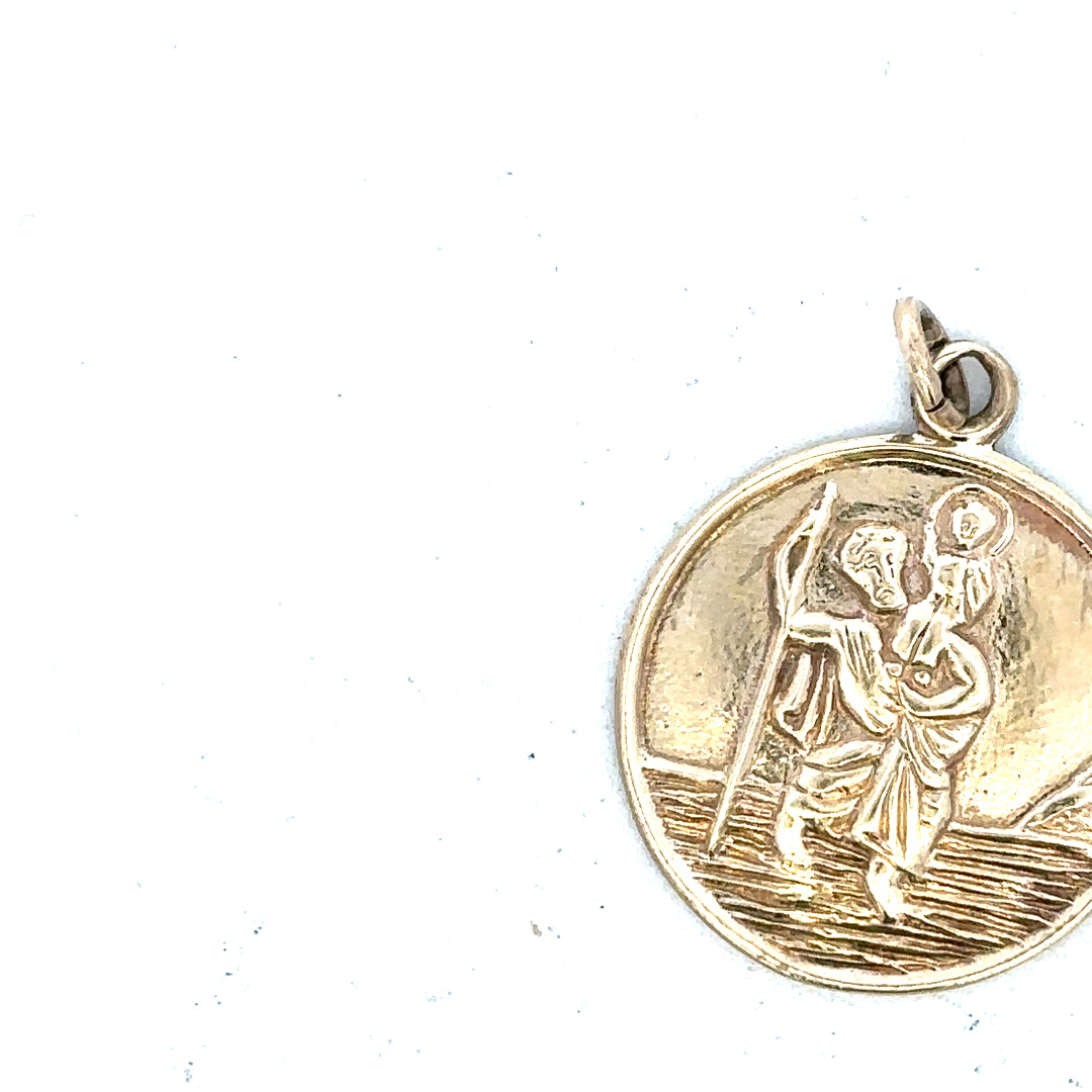 9ct yellow gold St. Christopher pendant, unbranded, featuring detailed religious medal design, weighs 5.7 grams.