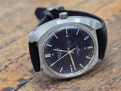 Longines 1972 Munich Olympics watch with gold-tone case and black leather strap, showcasing vintage sports design.