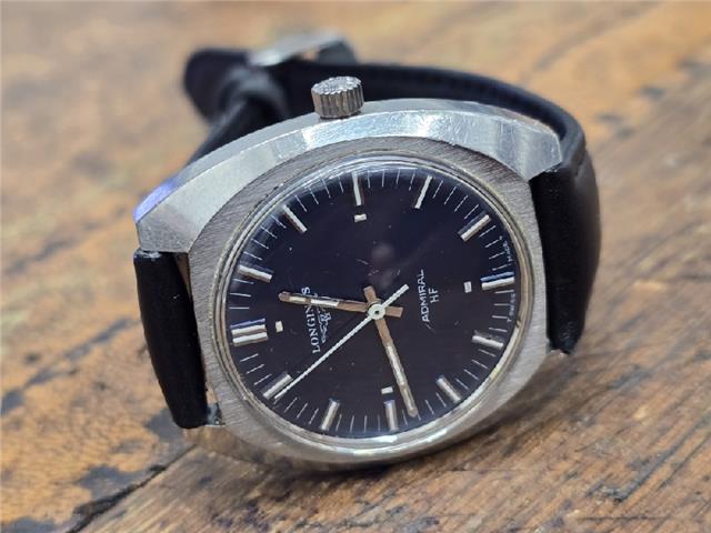 Longines 1972 Munich Olympics watch with gold-tone case and black leather strap, showcasing vintage Olympic design.