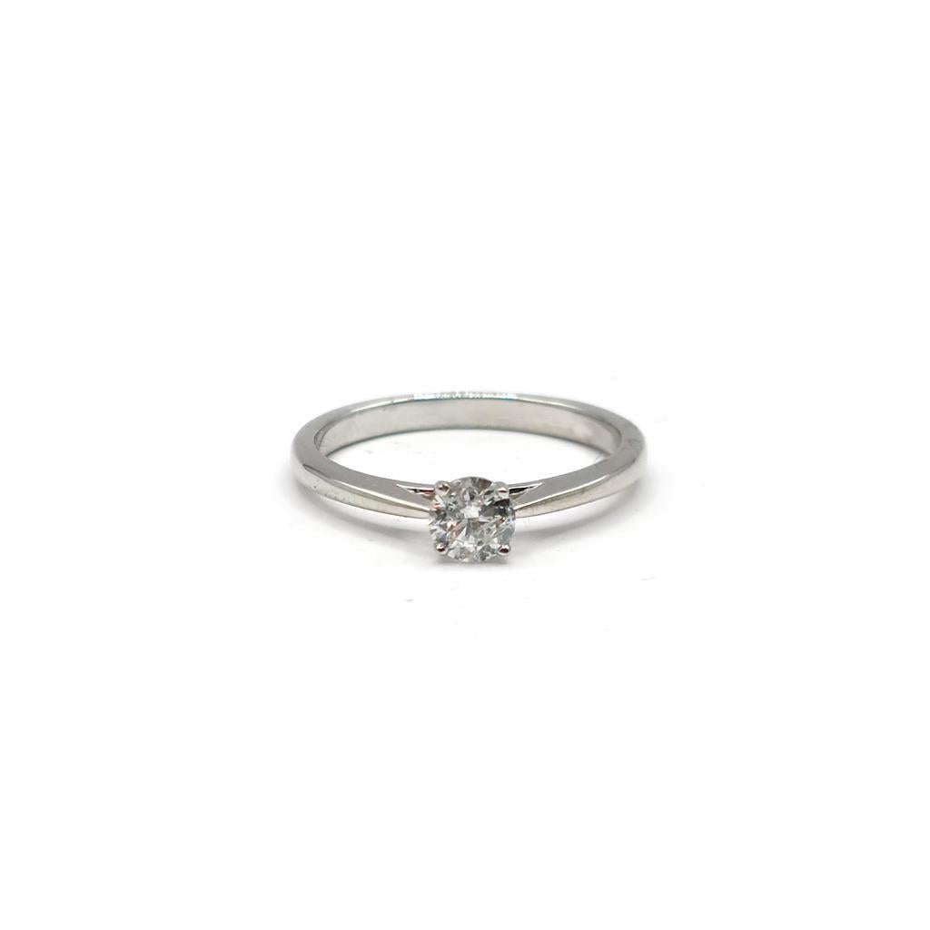 Platinum diamond solitaire ring featuring a 0.26 carat round-cut diamond on a sleek band.