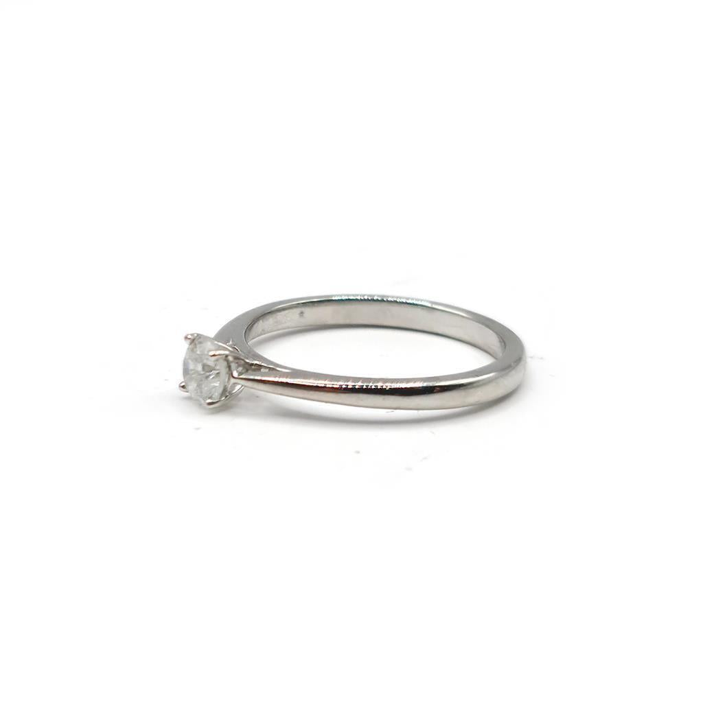 Platinum 0.26 carat diamond solitaire ring with a sleek band and a sparkling center diamond.