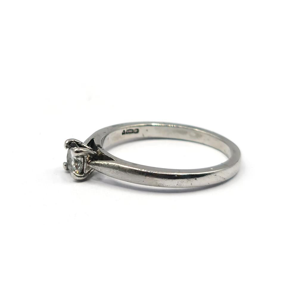 Platinum solitaire ring with a 0.30 carat brilliant cut diamond, showcasing a sleek and elegant jewelry design.