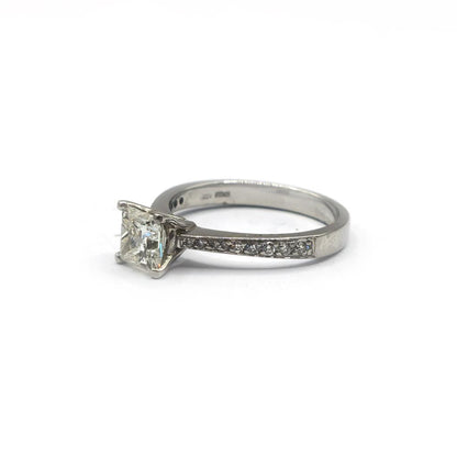Platinum 1.00 carat princess cut diamond ring with a sleek band, featuring a sparkling square-cut central diamond.