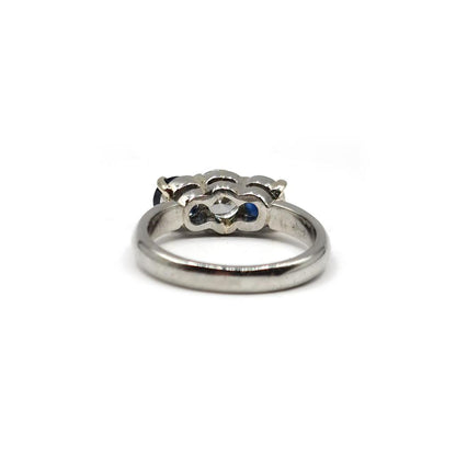 Platinum ring featuring a 1/2 carat diamond and 0.80 carat sapphire gemstone, elegant jewelry with intricate setting.