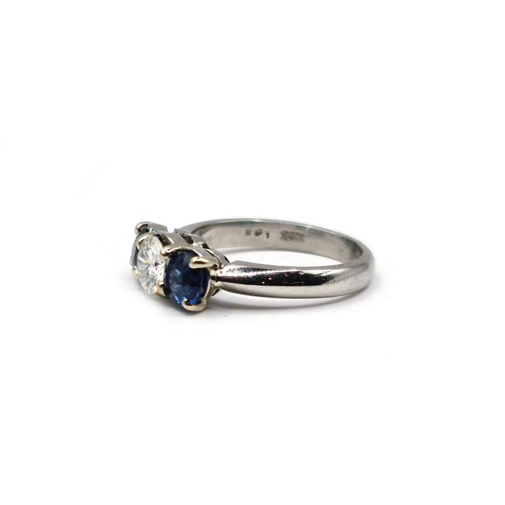 Platinum ring with a 1/2 carat diamond and 0.80 carat sapphire, featuring a sleek and elegant design.
