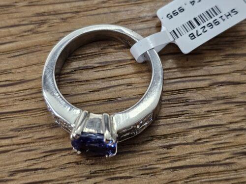 Platinum ring featuring a 1.79-carat tanzanite center stone surrounded by 1.60-carat diamonds, elegant jewelry design.