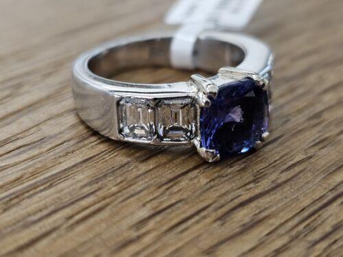 Platinum ring featuring a 1.79-carat tanzanite center stone surrounded by 1.60-carat diamonds, elegant jewelry design.