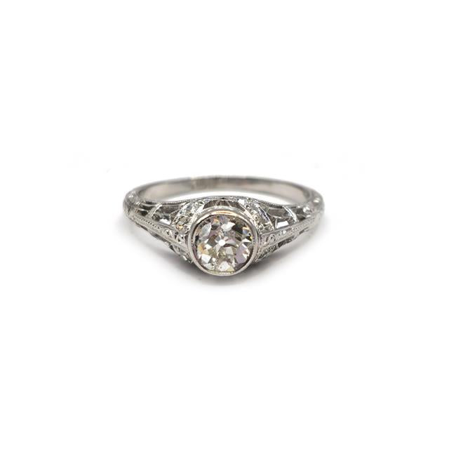 Platinum art deco diamond ring with intricate design and sparkling diamonds, unbranded jewelry piece.