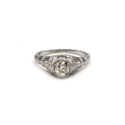 Platinum art deco diamond ring with intricate design and sparkling diamonds, unbranded jewelry piece.