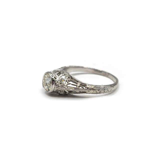 Platinum art deco diamond ring with intricate geometric details, showcasing sparkling diamonds and elegant craftsmanship.